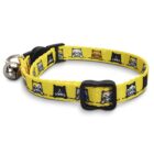 Yellow cat collar with a black buckle and a silver bell. The collar features a repeating pattern of cartoon cat faces in black, white, and orange on a yellow background.