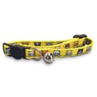 Yellow cat collar featuring a pattern of cartoon cat faces in various colors. It has a black buckle and a small silver bell attached.