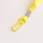 Yellow lanyard with plastic hook and metal clasp on a light background.