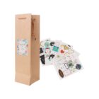 Tall brown gift bag with a floral label, next to assorted decorative stickers.