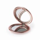 Rose gold compact mirror, open with two reflective surfaces.