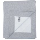 Folded light gray blanket with one corner flipped to show white inner lining and a tag.