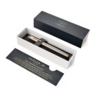 A gold and silver Parker pen in a gift box with an information card.