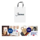 White paper bag with black handles and logo, with customization options below.
