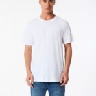 Man wearing a plain white T-shirt and blue jeans standing against a white background.