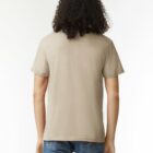 Person with curly hair wearing a beige t-shirt and blue jeans, shown from the back.