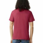 Person with curly hair wearing a red t-shirt and blue jeans, seen from the back.