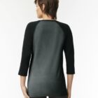 Person wearing a black and gray raglan shirt, shown from the back against a light background.