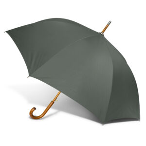 A custom green umbrella with a wooden handle, opened and angled to the left.