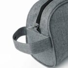Close-up of a gray fabric pouch with a zipper and a handle.