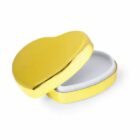 A small, open, gold-colored heart-shaped box with a white interior.