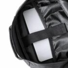 Open black backpack with a laptop secured inside.