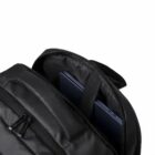 Black backpack with a laptop partially visible in the open compartment against a white background.