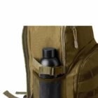 Olive backpack with a black bottle in mesh side pocket.