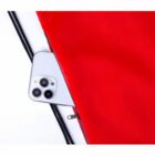 Smartphone peeking from a red zippered bag on a white surface.