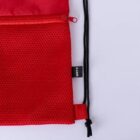 Red mesh bag with a zipper and black drawstring on a light background.