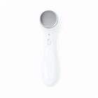 White handheld massager with a round metal head.