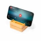 Smartphone on a wooden stand playing a video.