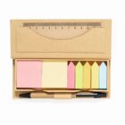 Stationery set with sticky notes, ruler, and pen in a cardboard holder.