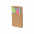A set of colored sticky notes in Tetris-like shapes in a brown cardboard holder.