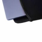 Laptop partially inside a black sleeve on a white background.