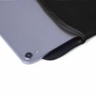 Tablet partially sliding out of a black case, showing the camera and corner detail.