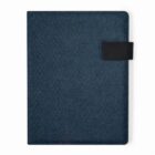A closed dark blue notebook with a black strap on the right side.