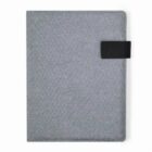 Gray fabric notebook with a black closure strap on the right side.