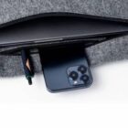 Phone and pen in a zippered gray fabric pouch.