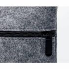 Close-up of a gray fabric zipper with a black pull tab.