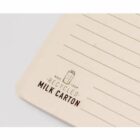 Notebook corner with lined pages, labeled Made from Recycled Milk Carton.