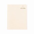 Beige notebook made from recycled milk cartons, closed and plain cover.