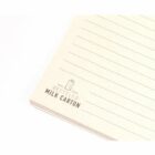 Lined notebook page with Made from recycled milk carton printed on it.