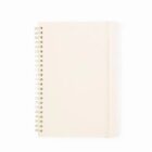 Closed spiral notebook with a plain beige cover on a white background.