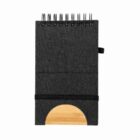 Dark spiral-bound notebook with a wooden semicircle accent at the bottom.