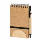 Small spiral notebook with a pen attached to the side, secured by an elastic band.