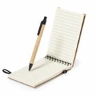 Open lined notebook with a pen placed vertically between the pages.
