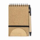 Spiral notepad with a pen attached, closed with an elastic band.