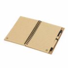 Open spiral notebook with lined pages and a pen in the holder on the right side.