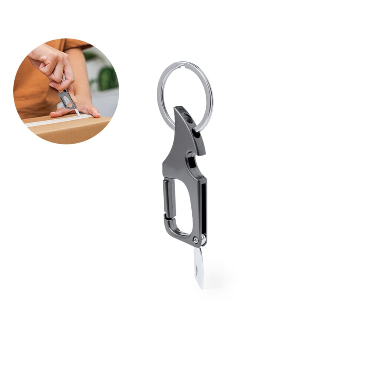 A carabiner keychain with a utility knife blade, shown cutting cardboard in a small inset circle.