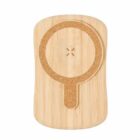 Wooden wireless charging pad with a circular design and a small handle-like extension.
