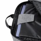 Laptop partially visible inside an open gray backpack with a padded compartment.