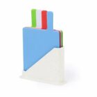 Four colorful cutting boards in a white holder.