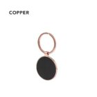 Copper keychain with a round black insert and a plain background.