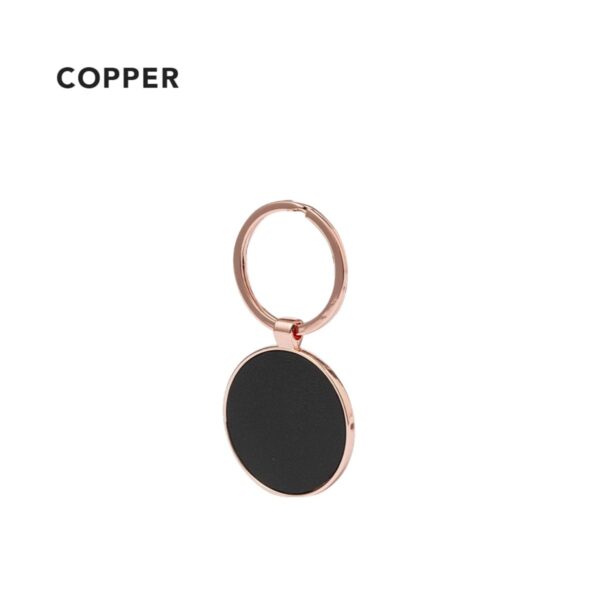 Copper keychain with a black circular pendant.