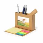 Desk organizer with pens, sticky notes, ruler, and a small framed picture of a child.