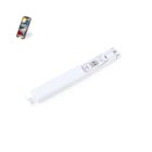 White selfie stick with a built-in USB port next to a smartphone displaying app icons.