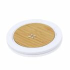 Round bamboo wireless charger with a white trim.