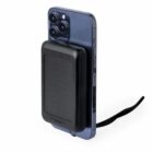 A smartphone with a black power bank attached to its back.