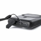 Black portable charger with USB ports and attached cable.